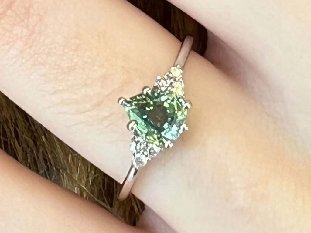 Matilde mint green sapphire and diamond ring worn on hand for scale