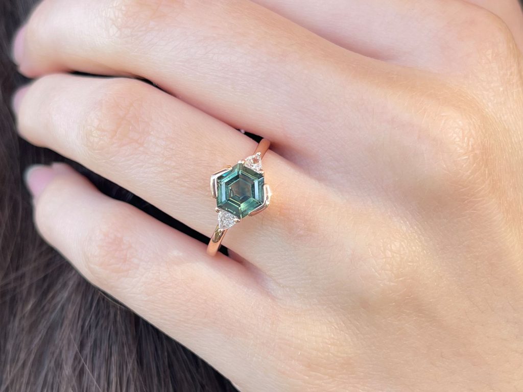 Trillare Teal sapphire and trilliant diamond ring worn on hand