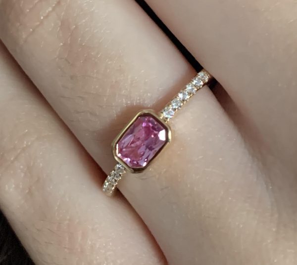Pink sapphire ring on hand
