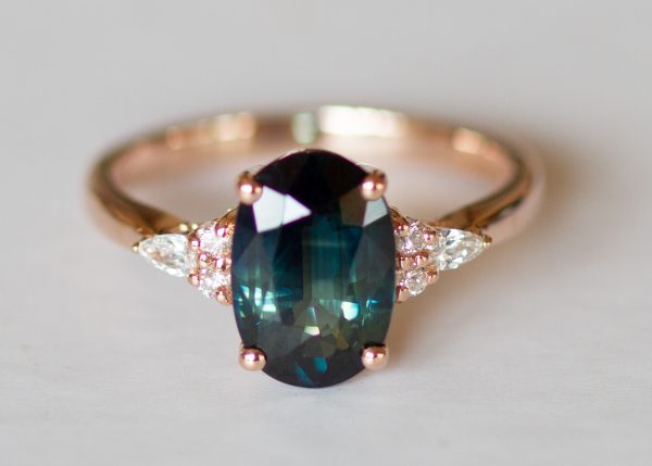 Teal peacock green oval sapphire and diamond ring