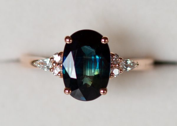 Teal peacock green oval sapphire and diamond ring