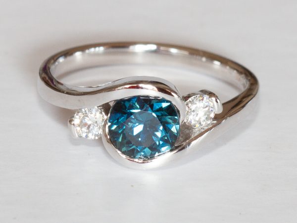 Round teal sapphire and diamond swirl ring