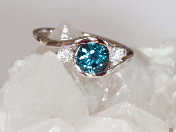 Round teal sapphire and diamond in white gold ring