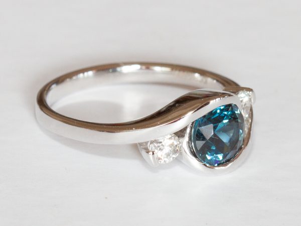 Round teal sapphire and diamond swirl ring